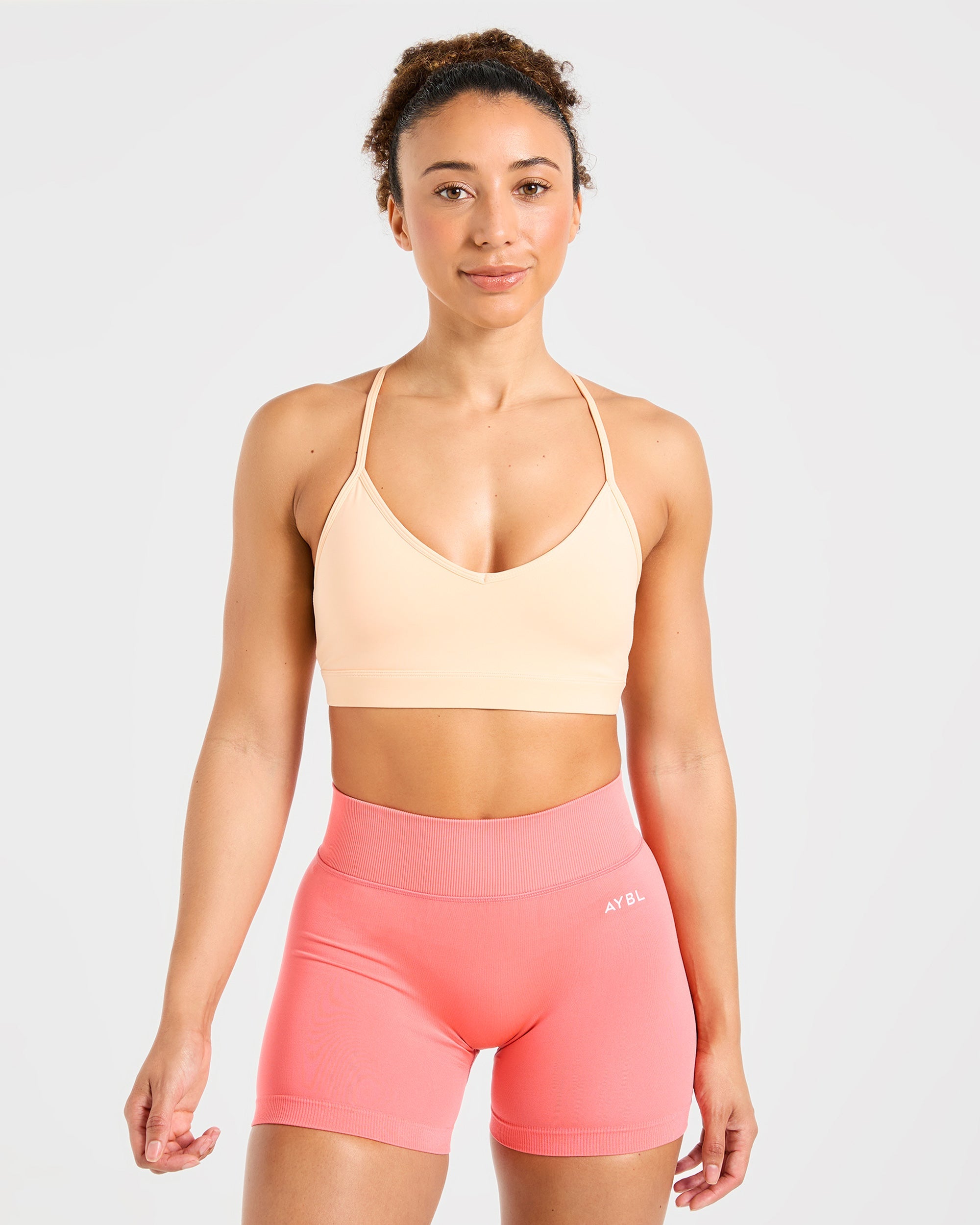 Sports Bra Essenziale con Scollatura a V e Cinturini - Pesca Pastello